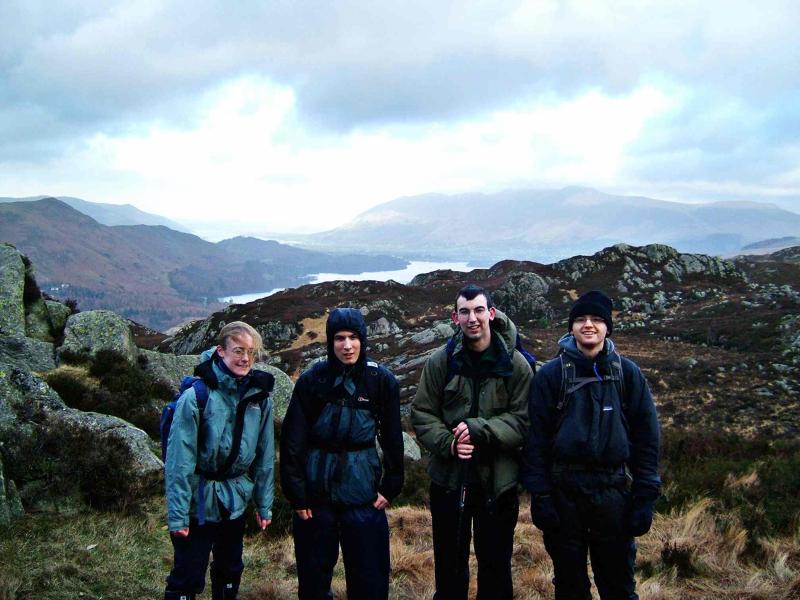 20050112-114714.jpg - Ruth, Phil, Mark and Zak shiver in the wind atop King's How, in front of Derwent Water and Skiddaw