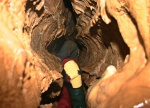 Emma wriggles back through the squeeze to the wet bit