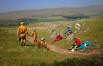 Children and adults enjoy the sun before entering Great Douk