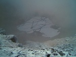 Fractured ice on the lochan far below