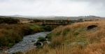 Lizzie and Mike crossing the Blackbrook River near the bunkhouse