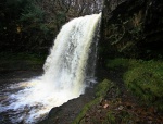 Jo and Alex emerge from behind the falls