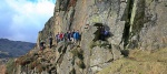A herd of hillwalkers thread through the notch of Side Pike